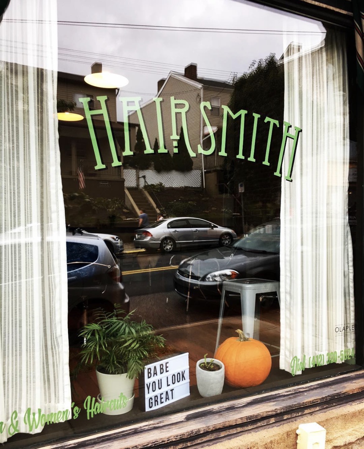 Hairsmith storefront on Penn Avenue with green window lettering